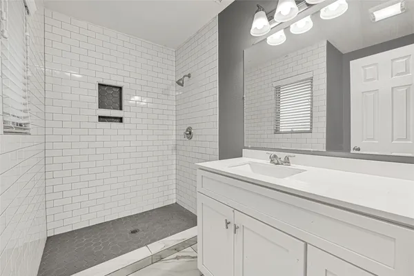 a bathroom with a sink a vanity and a mirror