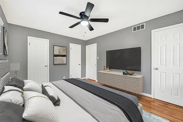 a bedroom with a bed and a flat screen tv