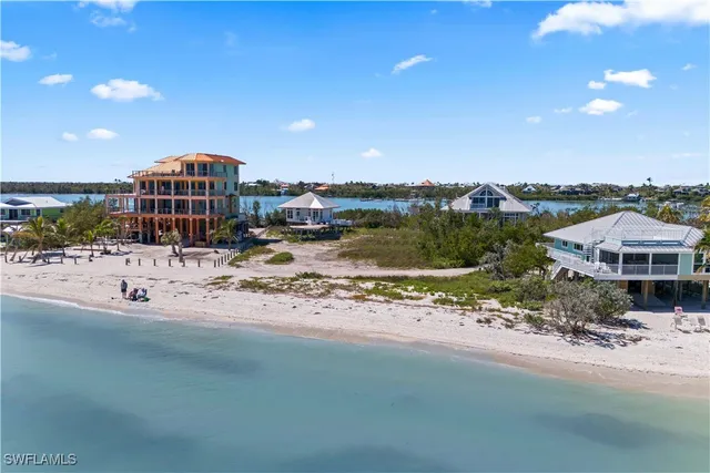an aerial view of a house with a ocean view