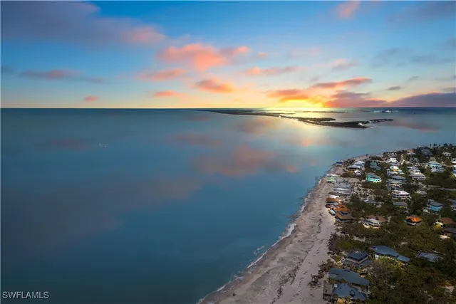 an aerial view of a houses with a lake view