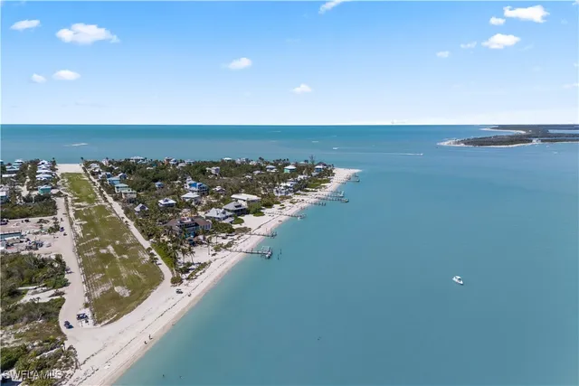 an aerial view of a house with swimming pool and ocean view