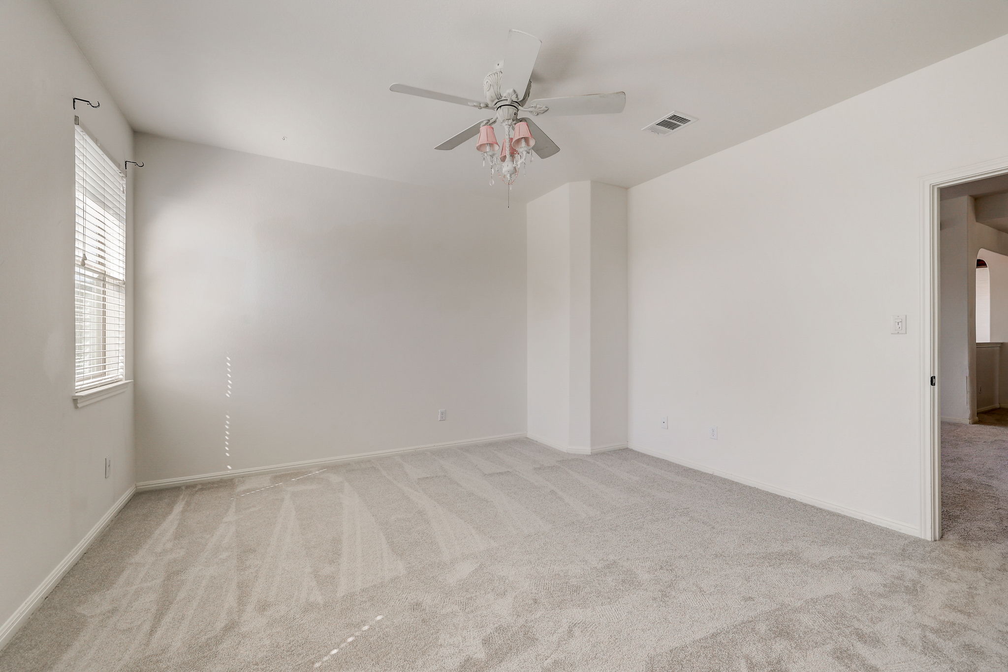 16012 Spillman Ranch Loop Austin, TX 78738 - Photo 24 of 38 A spacious room offers comfortable carpeting, ready for personalization.