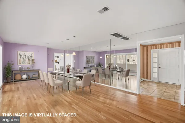 a view of a dining room with furniture window and wooden floor