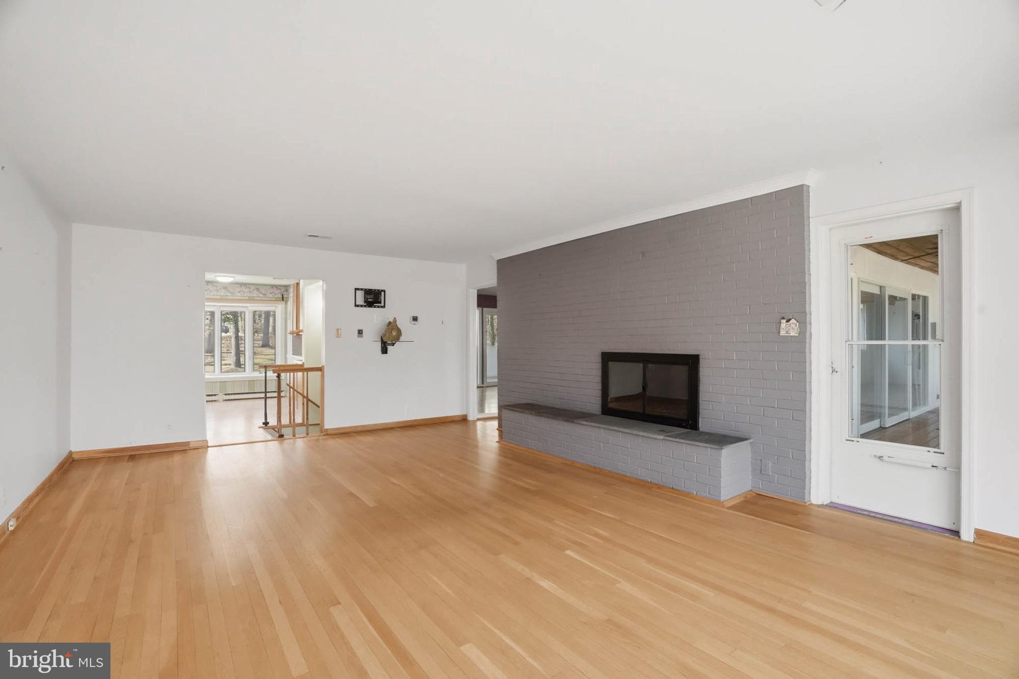 14917 Claude Lane Silver Spring, MD 20905 - Photo 15 of 52 a view of empty room with wooden floor and fireplace