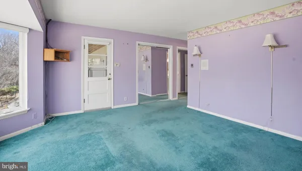 a view of an empty room with wooden shelves