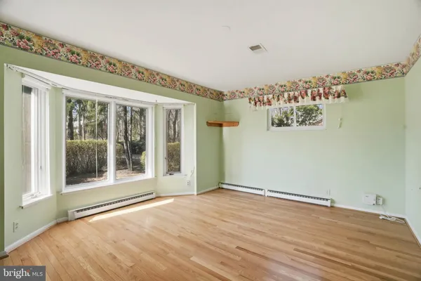 a view of a room with window wooden floor