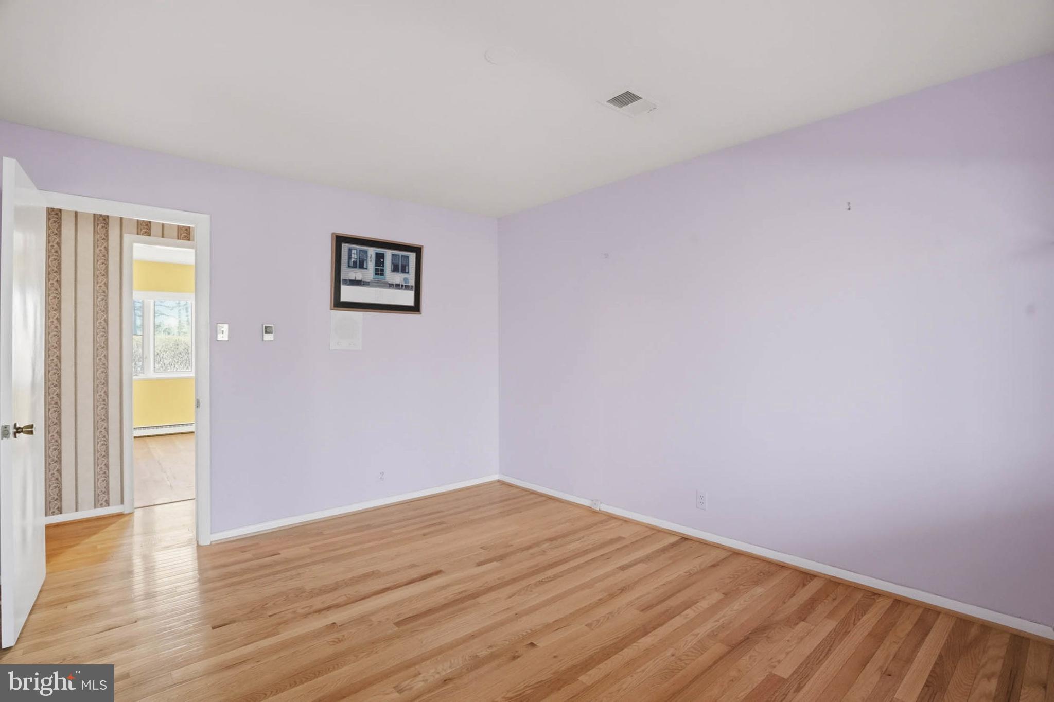 14917 Claude Lane Silver Spring, MD 20905 - Photo 27 of 52 a view of an empty room with wooden floor and a window