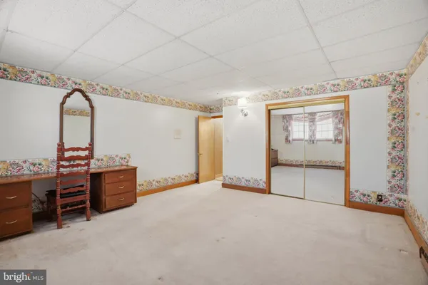 a view of an empty room with wooden shelves