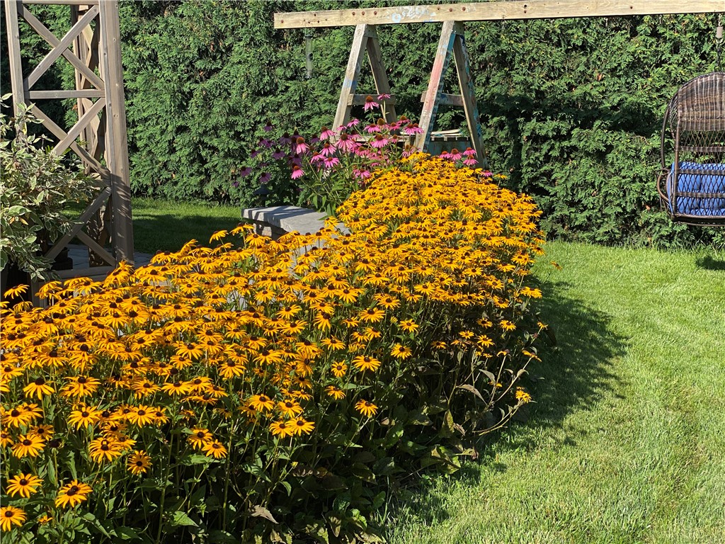 1092 Wickerton Lane Webster, NY 14580 - Photo 36 of 38 Flowers in bloom behind patio sitting wall.