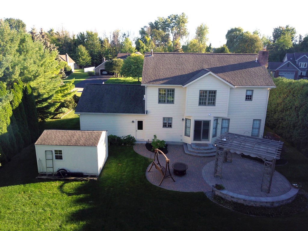 1092 Wickerton Lane Webster, NY 14580 - Photo 4 of 38 Rear patio with two sitting walls and landscape li