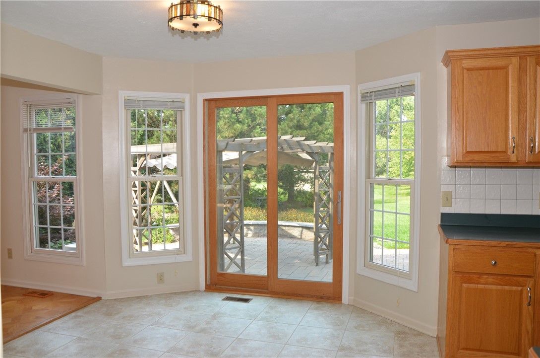 1092 Wickerton Lane Webster, NY 14580 - Photo 5 of 38 Light and bright kitchen overlooking beautiful pat