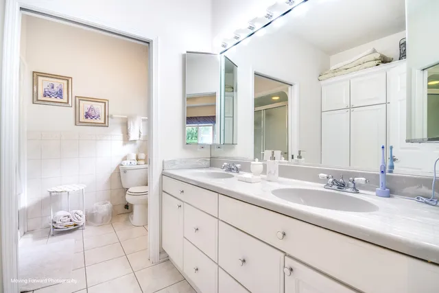 a spacious bathroom with a granite countertop sink mirror and toilet