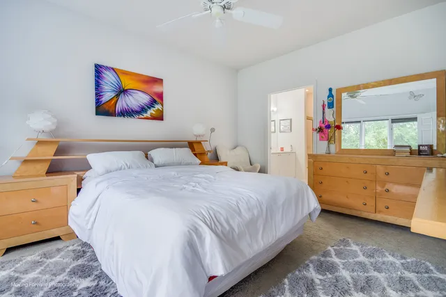 a bedroom with a bed and a dresser