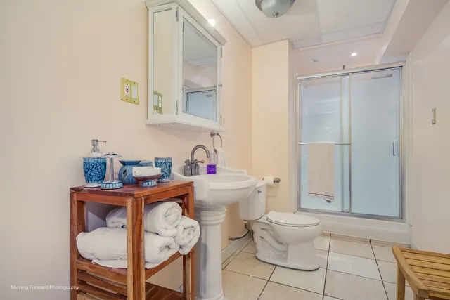 a bathroom with a toilet a sink and a mirror