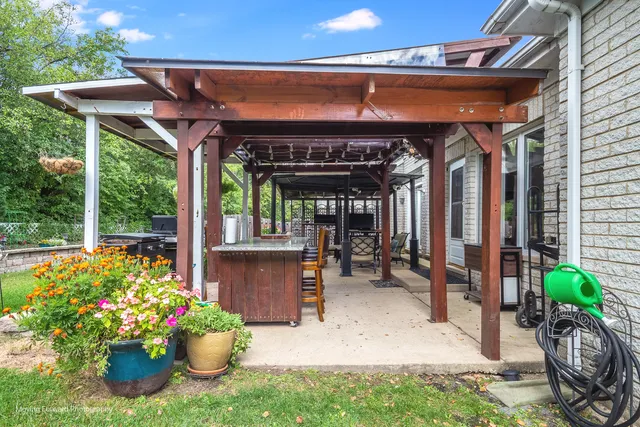 a view of a house with a backyard and porch