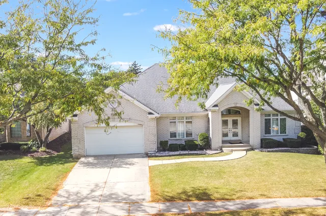 a front view of a house with swimming pool and sitting area