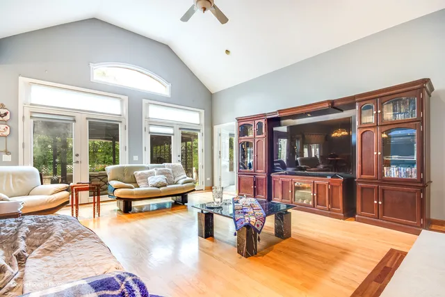a living room with furniture large window and flat screen tv