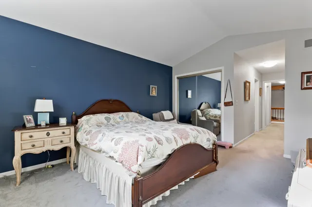 a bathroom with a granite countertop sink a toilet a large mirror a bathtub and shower