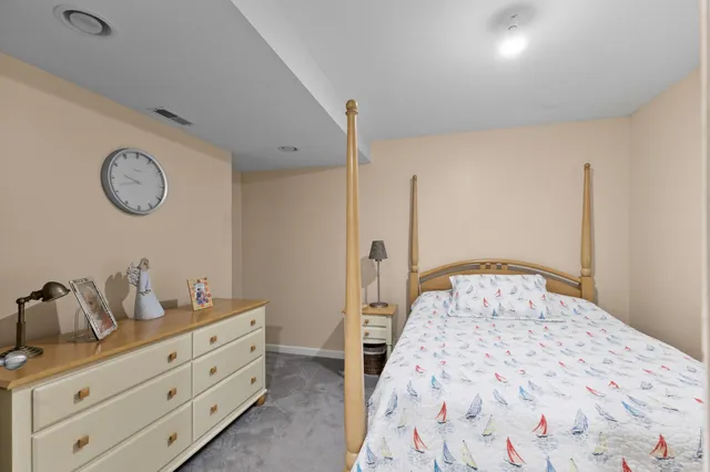 a bedroom with a bed and a night stand