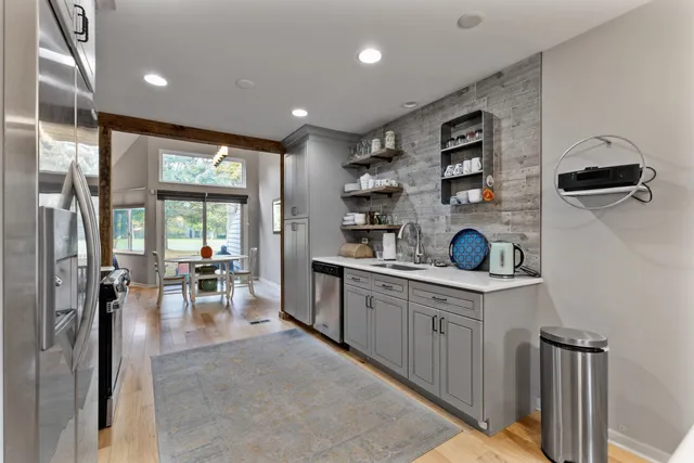 a kitchen with stainless steel appliances granite countertop a refrigerator and a sink