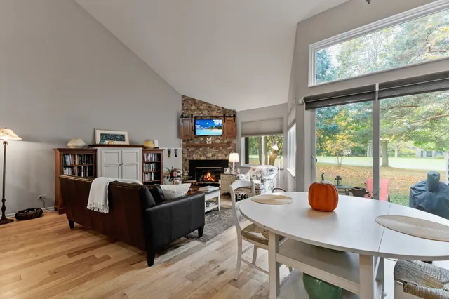 a living room with furniture a table and a large window