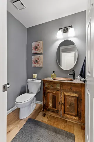 a bathroom with a toilet a sink and mirror