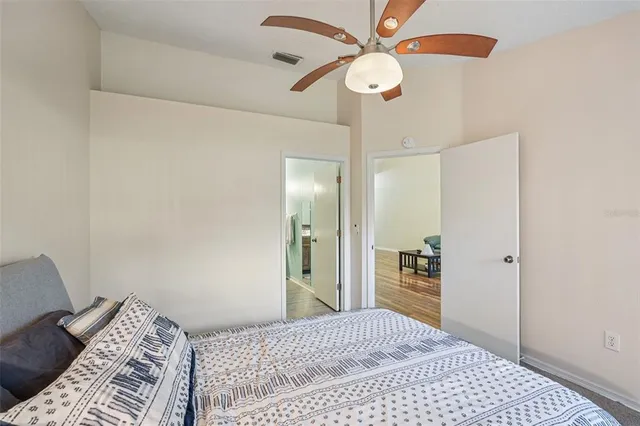 a bedroom with a bed and a chandelier