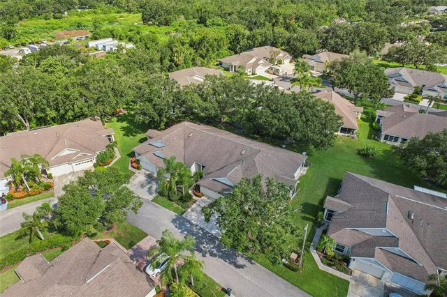 an aerial view of a house with a garden and mountain view