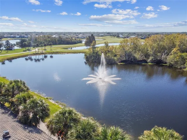 an aerial view of a residential houses with outdoor space and a lake view