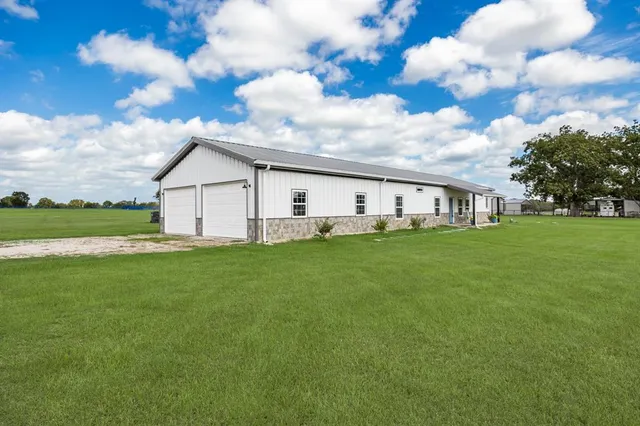 a front view of house with yard and green space