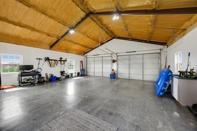 deck with table and chairs and potted plants