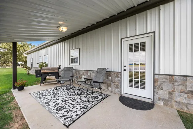 a view of a house with a yard and sitting area