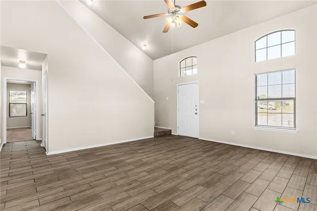 wooden floor in an empty room with a window
