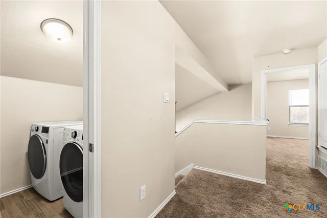 a view of storage and utility room with washer and dryer
