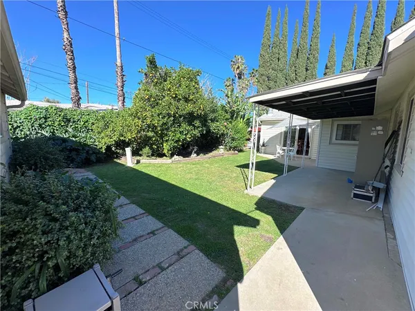 a view of yard with patio