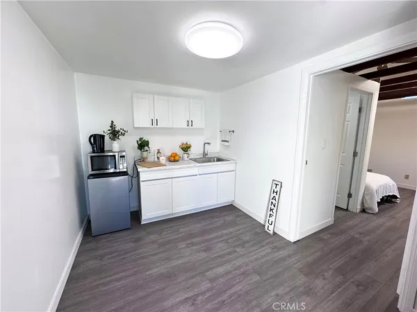 a utility room with cabinets washer and dryer