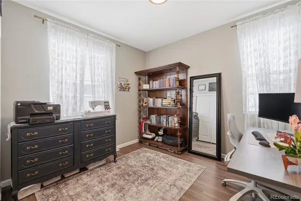 a view of a workspace with furniture and a window