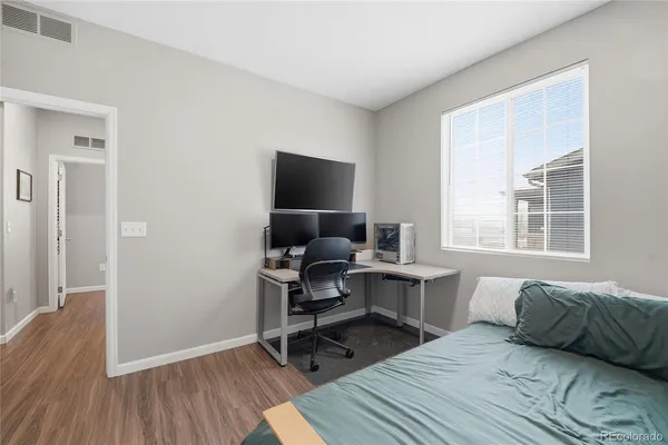 a view of a livingroom with workspace and a window