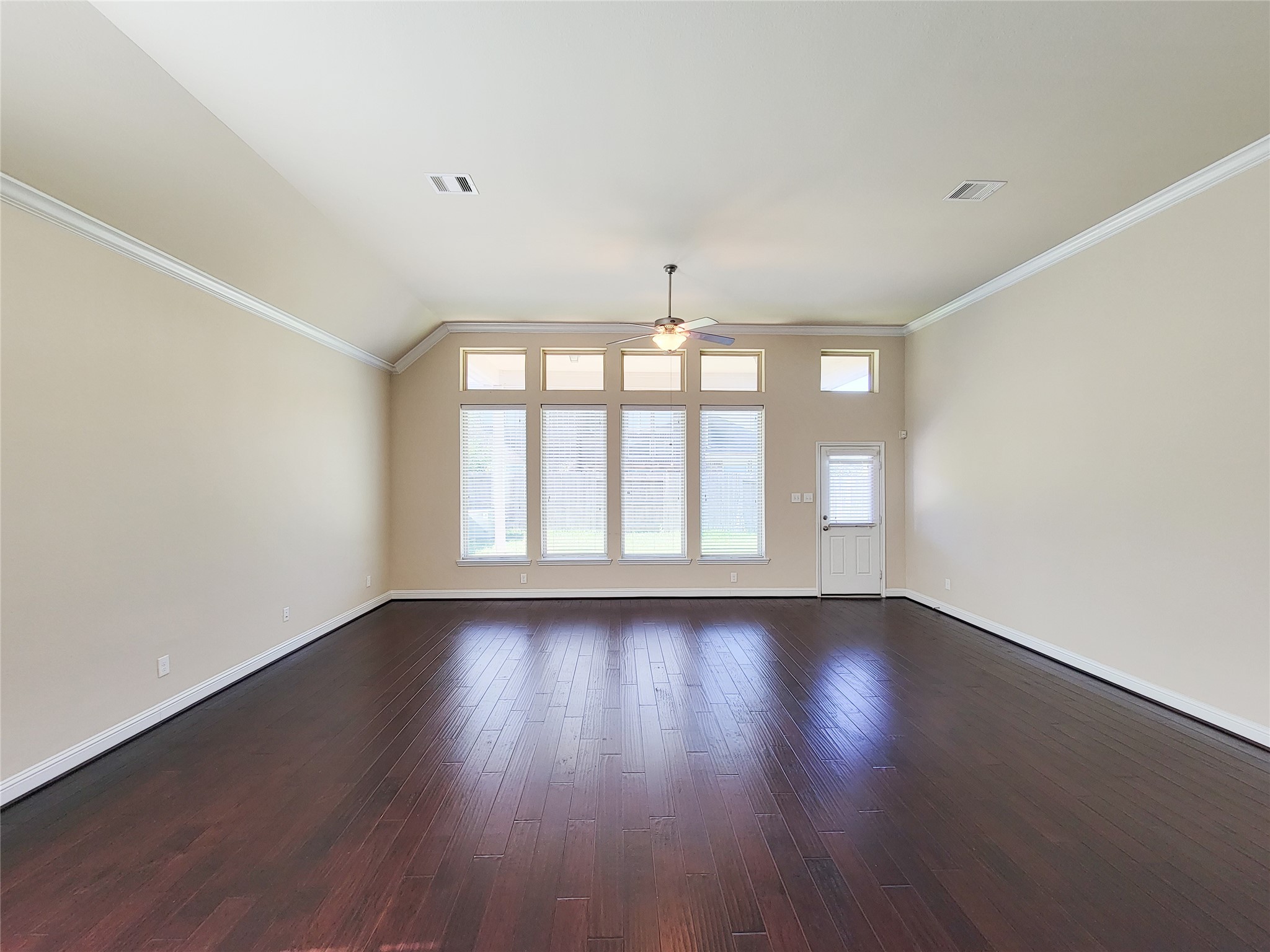 4102 Astoria Manor Lane Fulshear, TX 77441 - Photo 14 of 42 a view of an empty room with wooden floor and a window