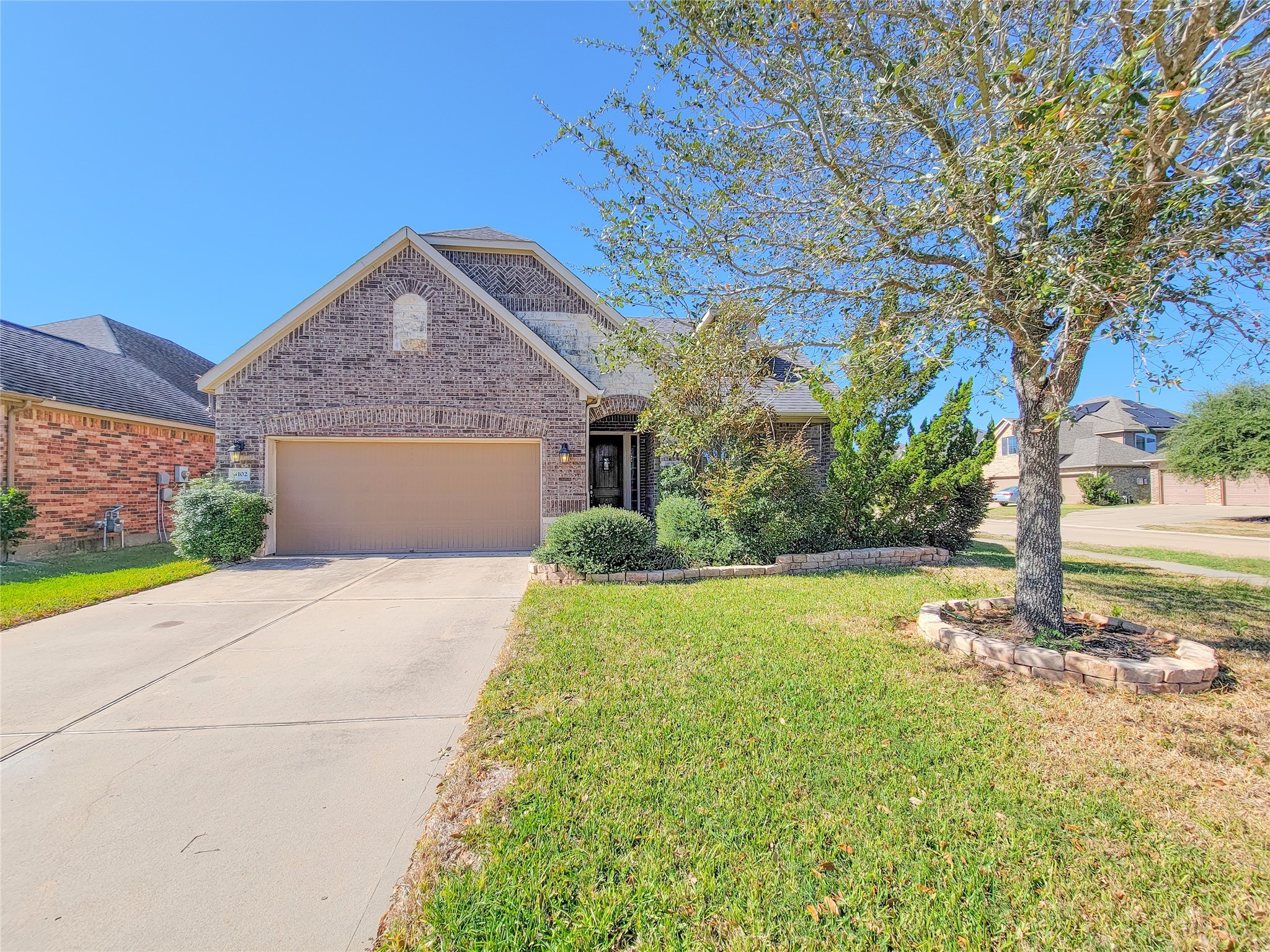 4102 Astoria Manor Lane Fulshear, TX 77441 - Photo 2 of 42 a front view of a house with a yard and a tree