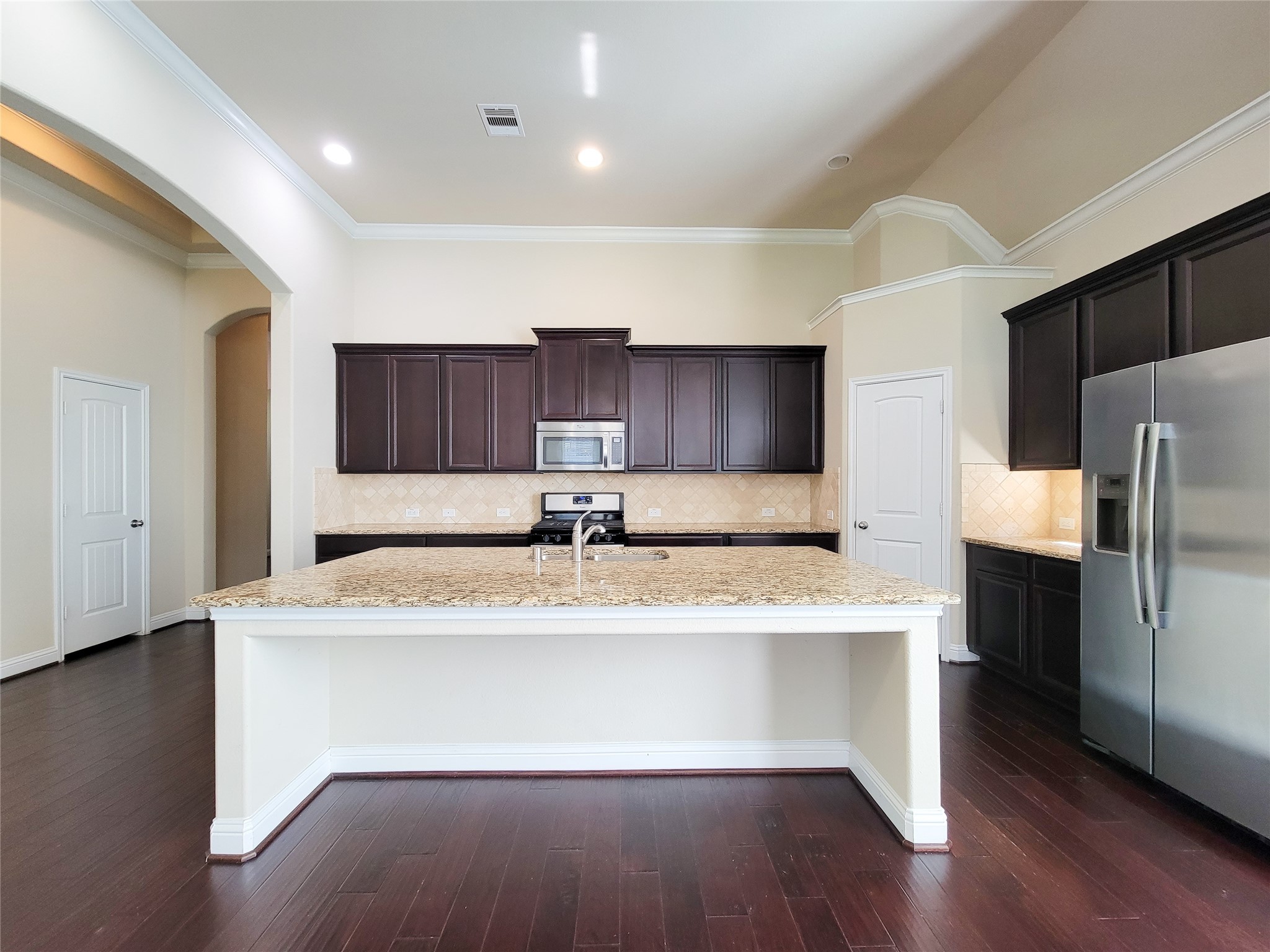 4102 Astoria Manor Lane Fulshear, TX 77441 - Photo 5 of 42 a view of kitchen with granite countertop cabinets and wooden floor