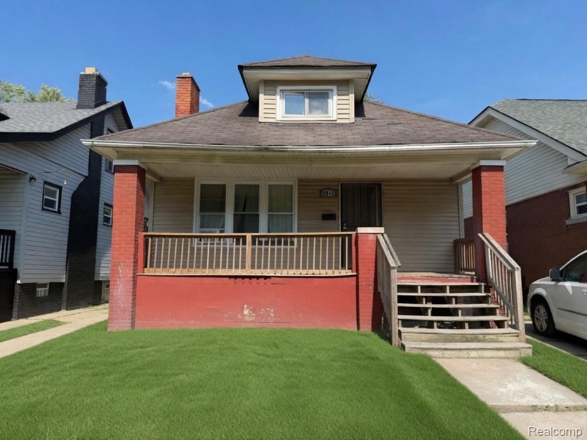 9940 Manor Detroit, MI 48204 - Photo 1 of 16 Front exterior with light-colored siding and a red brick base