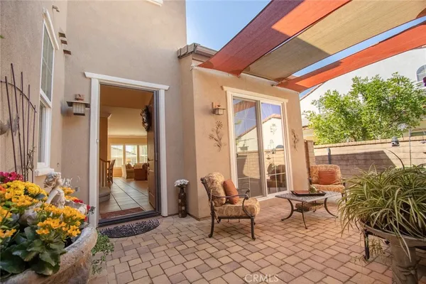a bedroom with a bed and a lamp on dresser