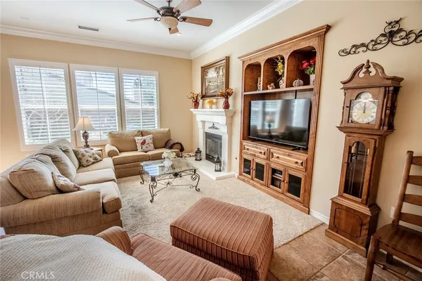a living room with furniture a flat screen tv and a large window