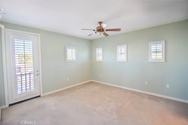 a view of a kitchen with fridge and workspace