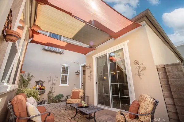 a building outdoor space with patio furniture and potted plants