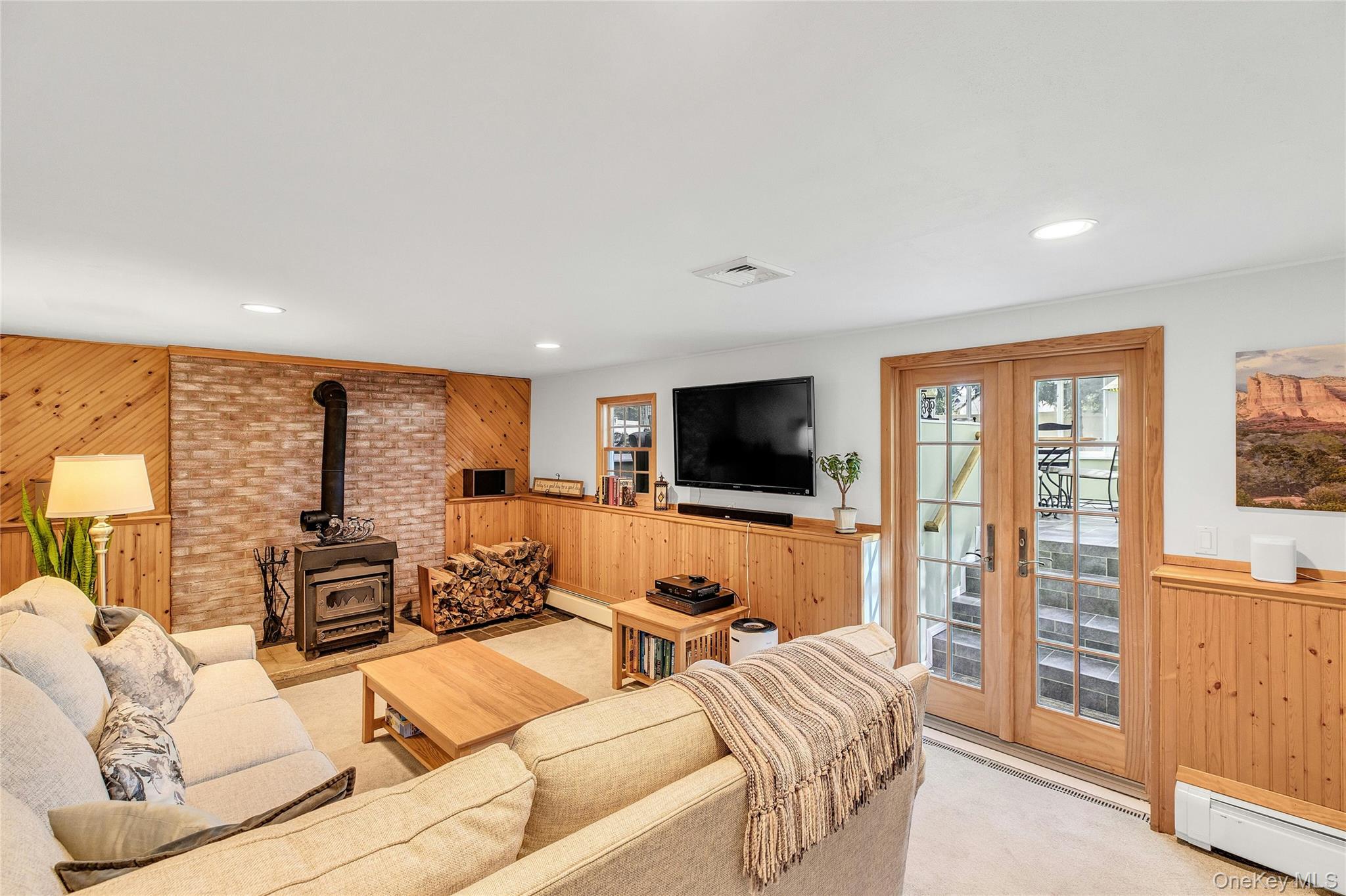 114 Lowell Road Sayville, NY 11782 - Photo 14 of 20 a living room with furniture a flat screen tv and a large window