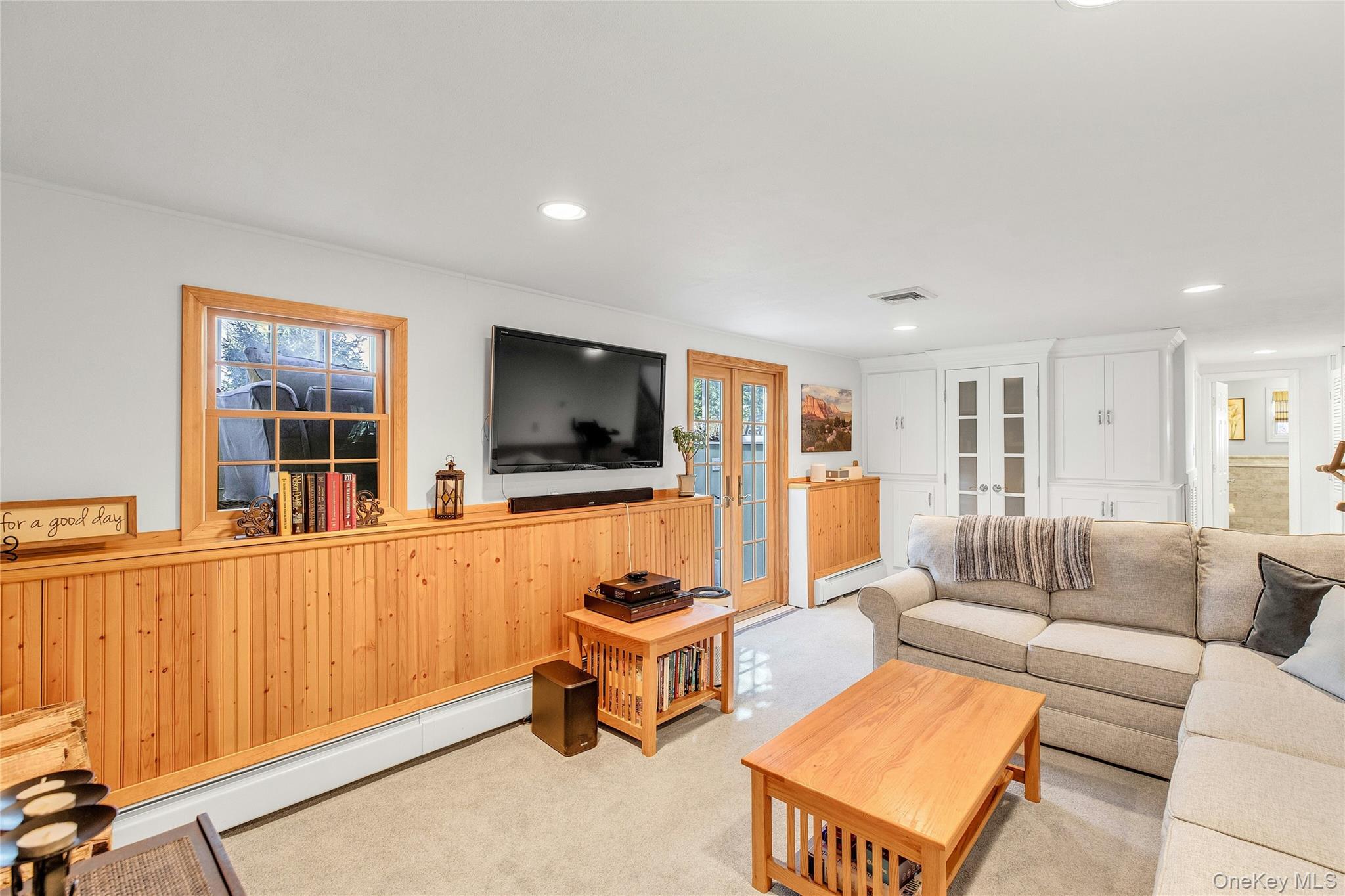114 Lowell Road Sayville, NY 11782 - Photo 15 of 20 a living room with furniture and a flat screen tv