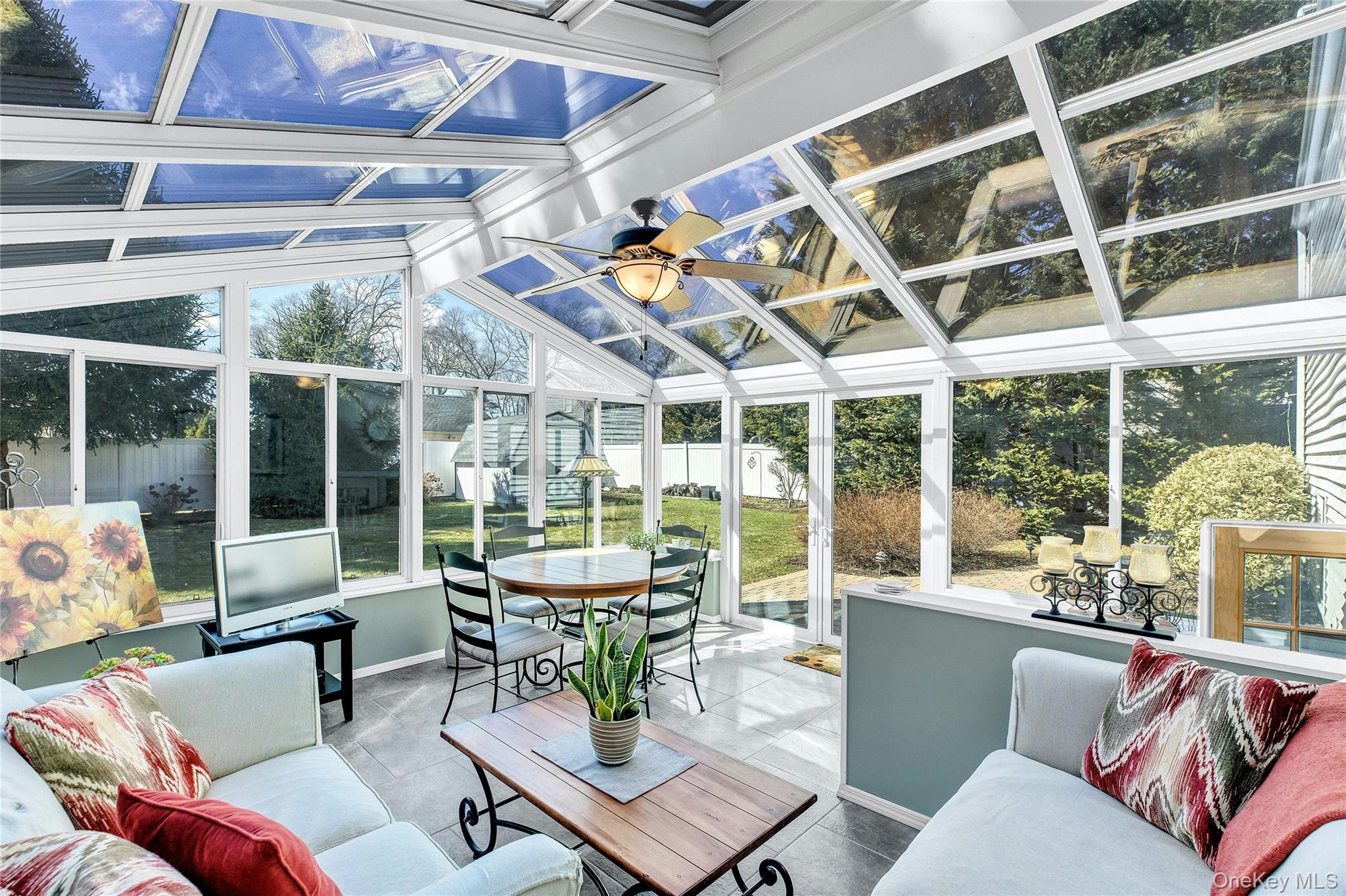 114 Lowell Road Sayville, NY 11782 - Photo 17 of 20 a view of a patio with couches and dining table and chairs with wooden floor