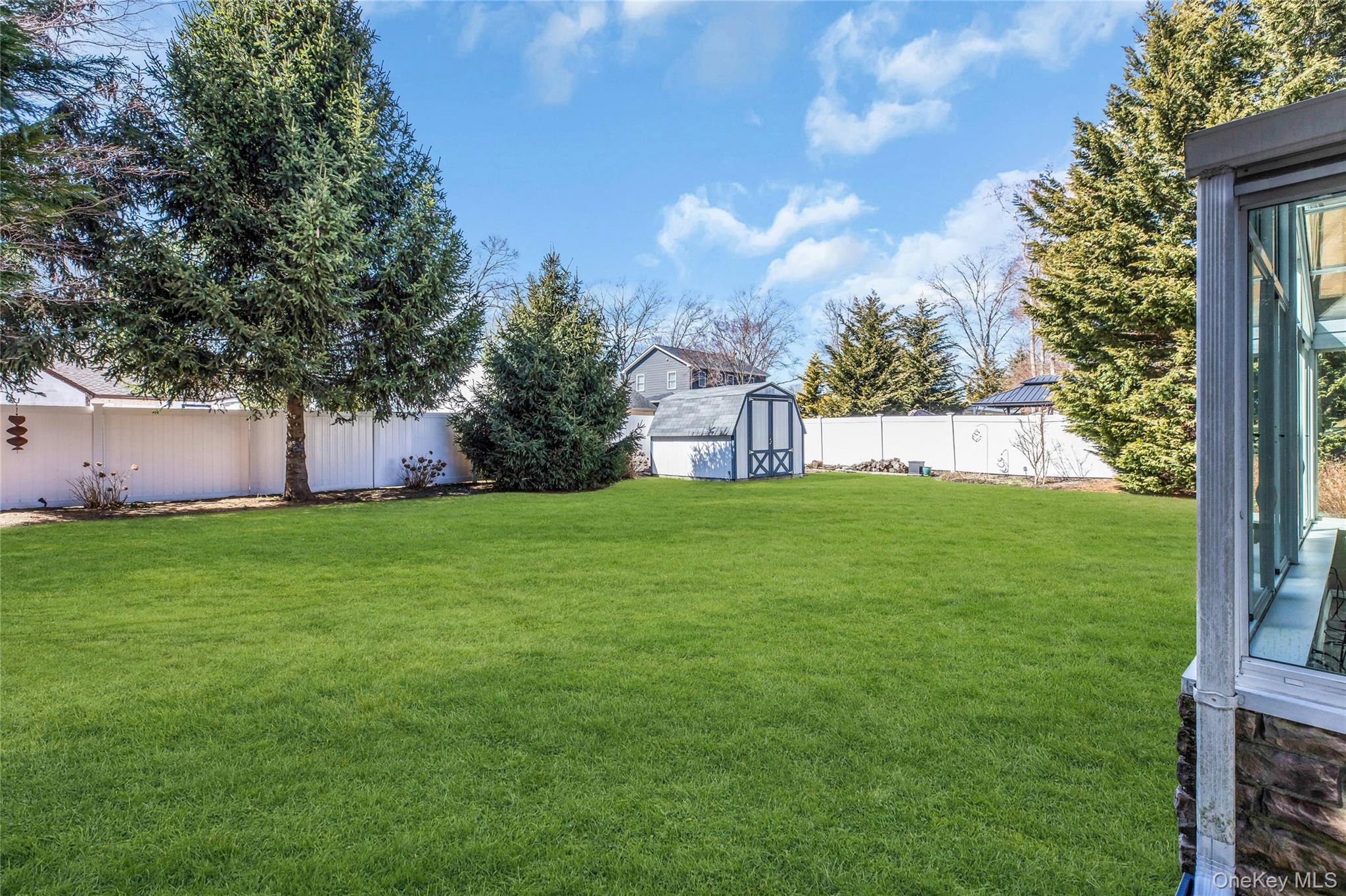 114 Lowell Road Sayville, NY 11782 - Photo 18 of 20 a view of a house with a yard potted plants and large tree
